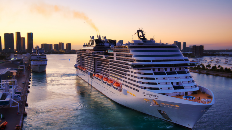 MSC cruise ship docked at Port Miami at sunset with Miami skyline in background