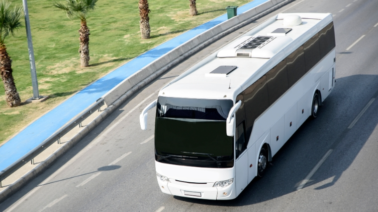 Larry's Limo motor coach charter bus driving to Miami's Hard Rock Stadium for group event